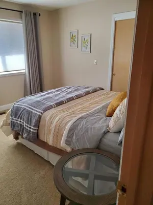 a bedroom with a bed and a glass table at Grass Valley Oasis - Spacious Family Retreat Near Rollins Lake in Grass Valley