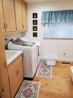 a kitchen with a washing machine and a sink at Grass Valley Oasis - Spacious Family Retreat Near Rollins Lake in Grass Valley