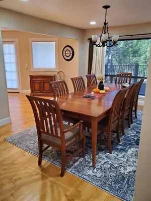 a dining room with a wooden table and chairs at Grass Valley Oasis - Spacious Family Retreat Near Rollins Lake in Grass Valley