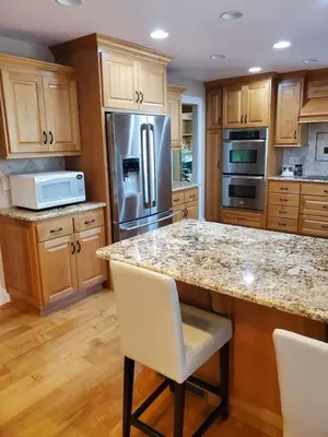 a kitchen with wooden cabinets and stainless steel appliances at Grass Valley Oasis - Spacious Family Retreat Near Rollins Lake in Grass Valley
