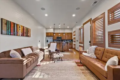 a living room with two couches and a kitchen at Reno Basecamp 2 King Suites, Walk to Food and Fun in Reno