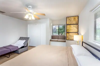 a bedroom with a bed and a ceiling fan at Grand Riverside Retreat - Private Walkway to the River in Three Rivers