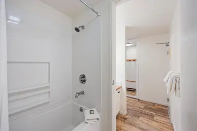 a white bathroom with a tub and a sink at 114 Bldg B condo in Truckee
