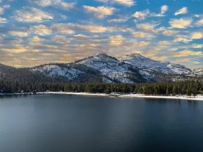 a view of a lake with snow capped mountains at 114 Bldg B condo in Truckee