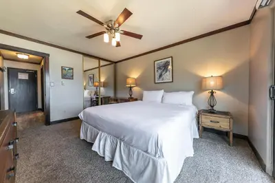 a bedroom with a white bed and a ceiling fan at 247 Bldg C condo in Truckee