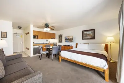a hotel room with a bed and a kitchen at 145 Bldg C condo in Truckee
