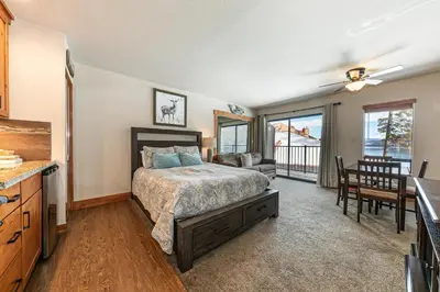 a bedroom with a bed and a table and chairs at 243 Bldg C condo in Truckee