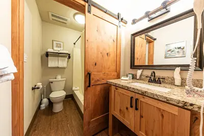 a bathroom with a sink and a toilet and a mirror at 243 Bldg C condo in Truckee