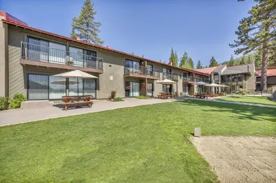 a large building with a picnic table and benches at 111 Bldg B condo in Truckee