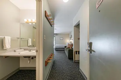 a bathroom with a sink and a room with a bed at 134 Bldg C studio in Truckee