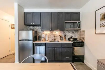 a kitchen with black cabinets and a stainless steel refrigerator at 245 Bldg C condo in Truckee