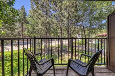 two chairs sitting on a porch with a fence at 211 Bldg B condo in Truckee