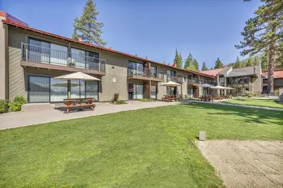 a large building with a patio and a yard at 211 Bldg B condo in Truckee