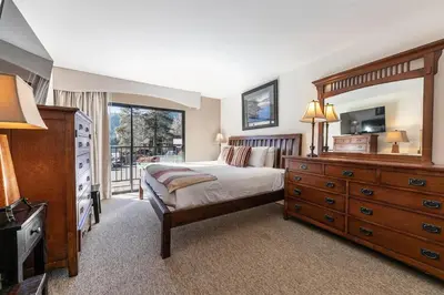 a bedroom with a bed and a dresser and a television at 222 Bldg B condo in Truckee