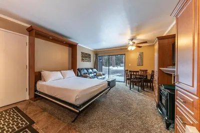 a bedroom with a bed and a living room at Cozy Deluxe Studio #131 at Donner Lake Village condo in Truckee
