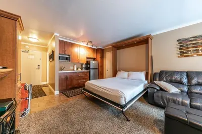 a bedroom with a bed and a couch in a room at Cozy Deluxe Studio #131 at Donner Lake Village condo in Truckee