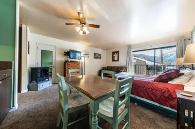 a living room with a dining room table and a bed at 224 Bldg B condo in Truckee