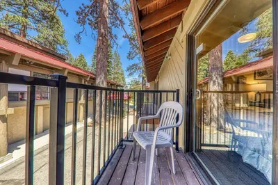 a white chair sitting on a porch with a fence at 217 Bldg B condo in Truckee