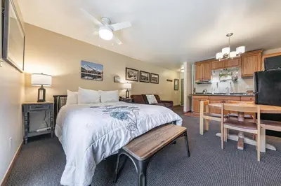 a large bedroom with a bed and a kitchen at 217 Bldg B condo in Truckee