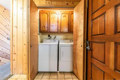 a washer and dryer in a kitchen with a door at 154 Bldg D townhouse in Truckee