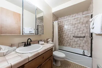 a bathroom with a sink and a toilet and a mirror at 154 Bldg D townhouse in Truckee