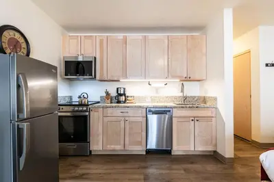 a kitchen with wooden cabinets and stainless steel appliances at 213 Bldg B condo in Truckee