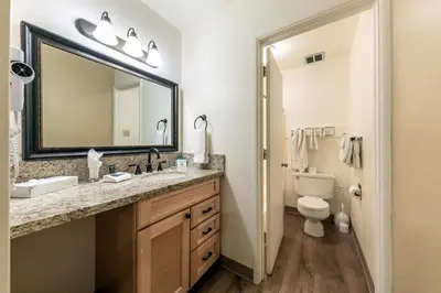 a bathroom with a sink and a toilet and a mirror at 213 Bldg B condo in Truckee
