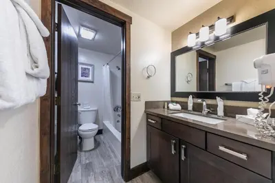 a bathroom with a sink and a toilet and a mirror at 122 Bldg B studio in Truckee