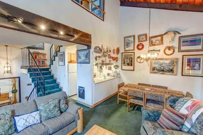 a living room with two couches and a staircase at Chamonix #093 - Near Skiing Hiking & More in Mammoth Lakes