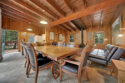 a dining room with a wooden table and chairs at Kit Carson Lodge in Kit Carson