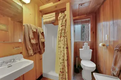 a bathroom with a toilet and a sink at Kit Carson Lodge in Kit Carson
