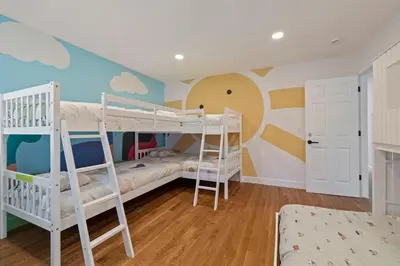 a bedroom with two bunk beds and a wall with clouds at New Listing - 5bd 3ba Retreat for a large group in Groveland
