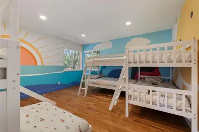 a bedroom with two bunk beds and a rainbow mural at New Listing - 5bd 3ba Retreat for a large group in Groveland
