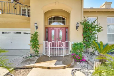 a house with a pink door with a fence at Golf, Fish and More Cozy Safari Unit in Atwater! in Atwater