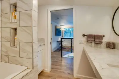 a bathroom with a walk in shower and a sink at Kaweah River Cabin - Pool, Hot Tub, Movie Projector in Three Rivers