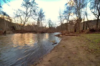 a stream of water with trees on the side of it at Tranquil Riverfront Studio in Three Rivers