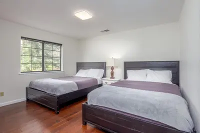 a bedroom with two beds and a window at Serene Riverfront Home - 150 yds from the River in Three Rivers