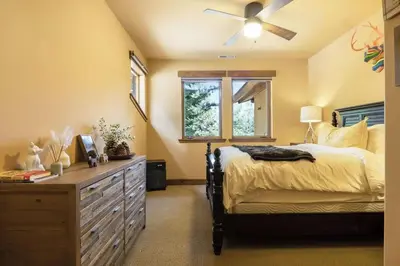 a bedroom with a bed and a ceiling fan at Star Haven Game Room & Forest Views in Truckee