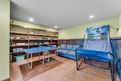 a room with a blue couch and a swing at Star Haven Game Room & Forest Views in Truckee