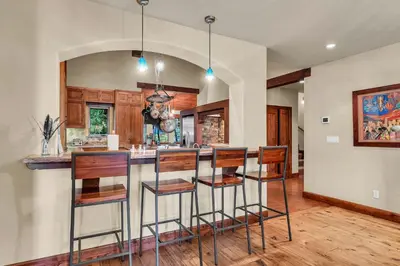 a kitchen with a bar with stools at Star Haven Game Room & Forest Views in Truckee