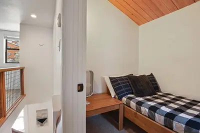 a small bedroom with a bed and a table at Northstar 2BR Walk to Village Bike Hike Rec Center in Truckee