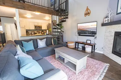 a living room with a couch and a fireplace at 2xKing, Balconies, 350mbps. Loft, Near Northstar in Kings Beach
