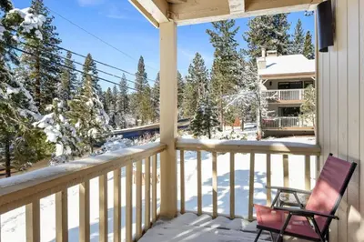 a chair sitting on a porch in the snow at 2xKing, Balconies, 350mbps. Loft, Near Northstar in Kings Beach