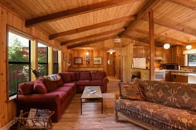 a large living room with couches and a kitchen at Serene Tahoe Donner Cabin mins to Lake, Ski, Golf in Truckee