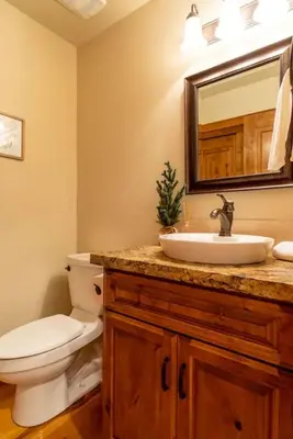 a bathroom with a toilet and a sink and a mirror at Kings Beach Family Retreat - Lake Views and Hot Tub in Kings Beach