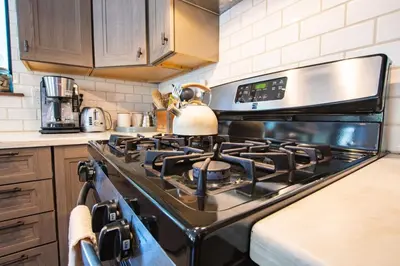 a kitchen with a stove with a tea kettle on it at A-Frame Cabin - Hot Tub , BBQ , Family Fun in Tahoe Vista