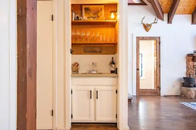 a kitchen with white cabinets and a sink at A-Frame Cabin - Hot Tub , BBQ , Family Fun in Tahoe Vista