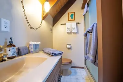 a bathroom with a sink and a toilet at A-Frame Cabin - Hot Tub , BBQ , Family Fun in Tahoe Vista