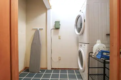 a laundry room with a washing machine and a washer at Charming Kings Beach Cabin, Hot Tub, Walk to Lake in Kings Beach