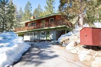 a house in the snow with a driveway at Walk to Palisades Village Pet Friendly 2BR Chalet in Olympic Valley